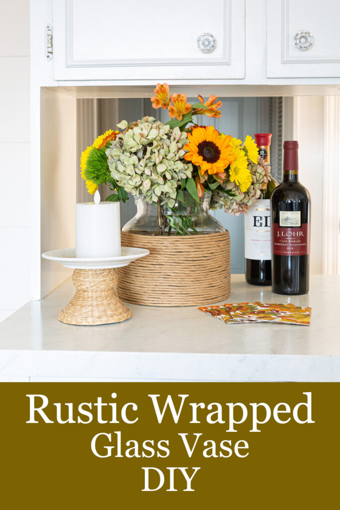 Twisted paper ribbon wrapped glass vase filled with fall flowers on kitchen counter