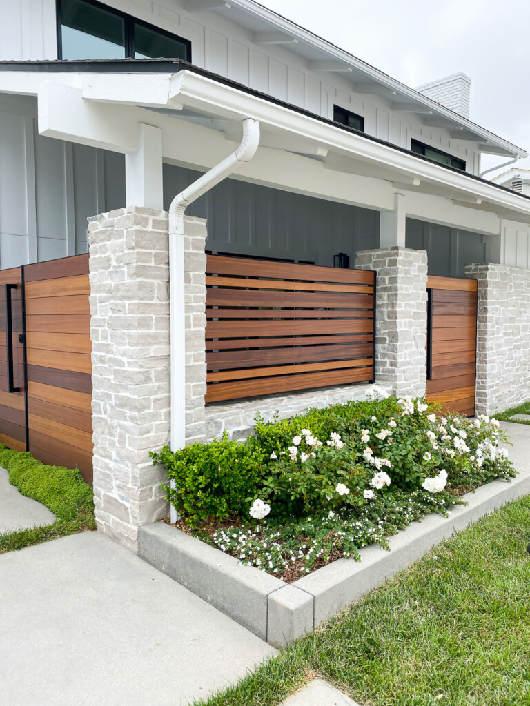 a house with a slat wall enclosure