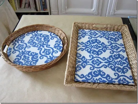 two wicker basket trays with blue and white decorative fabric inserts