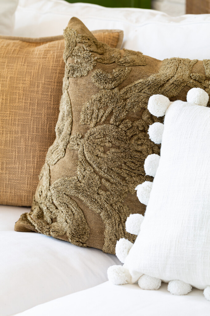 3 fall pillows lined up on white sofa