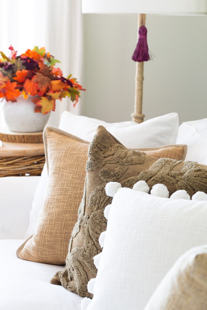 Neutral fall colored pillows on white sofa