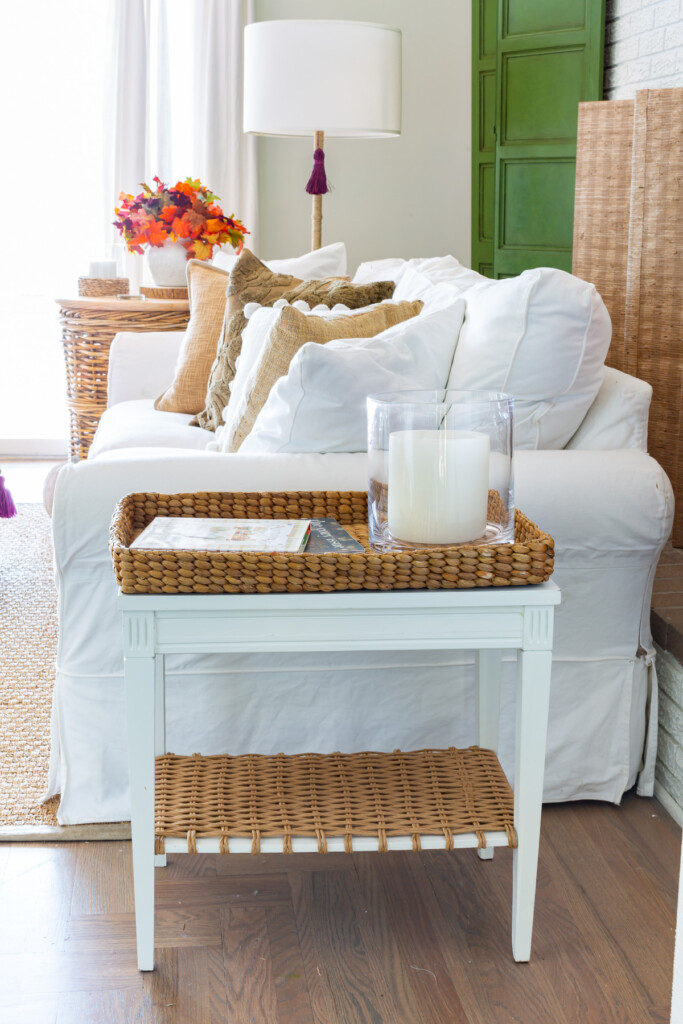 white sofa and table in living room decorated for fall