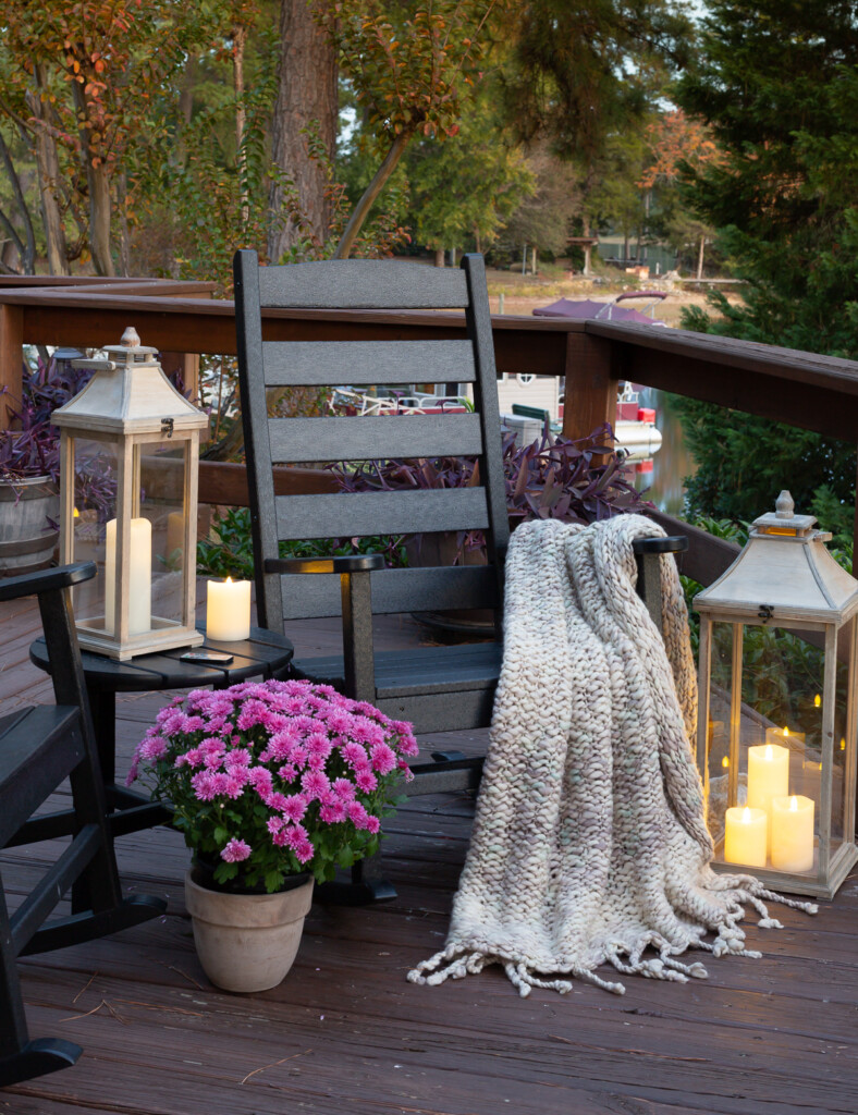 Cozy fall outdoor decor on lake side deck of a home
