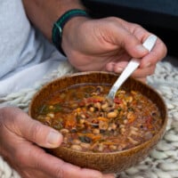 man holding a bowl of soup