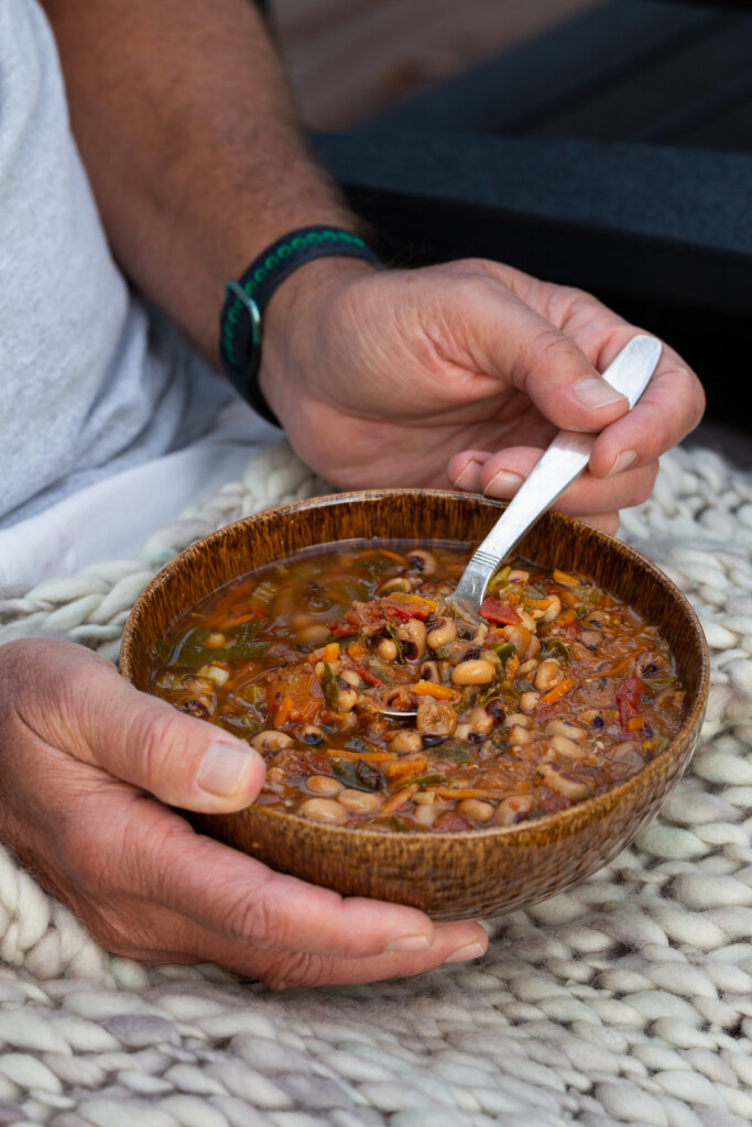 man holding a bowl of soup