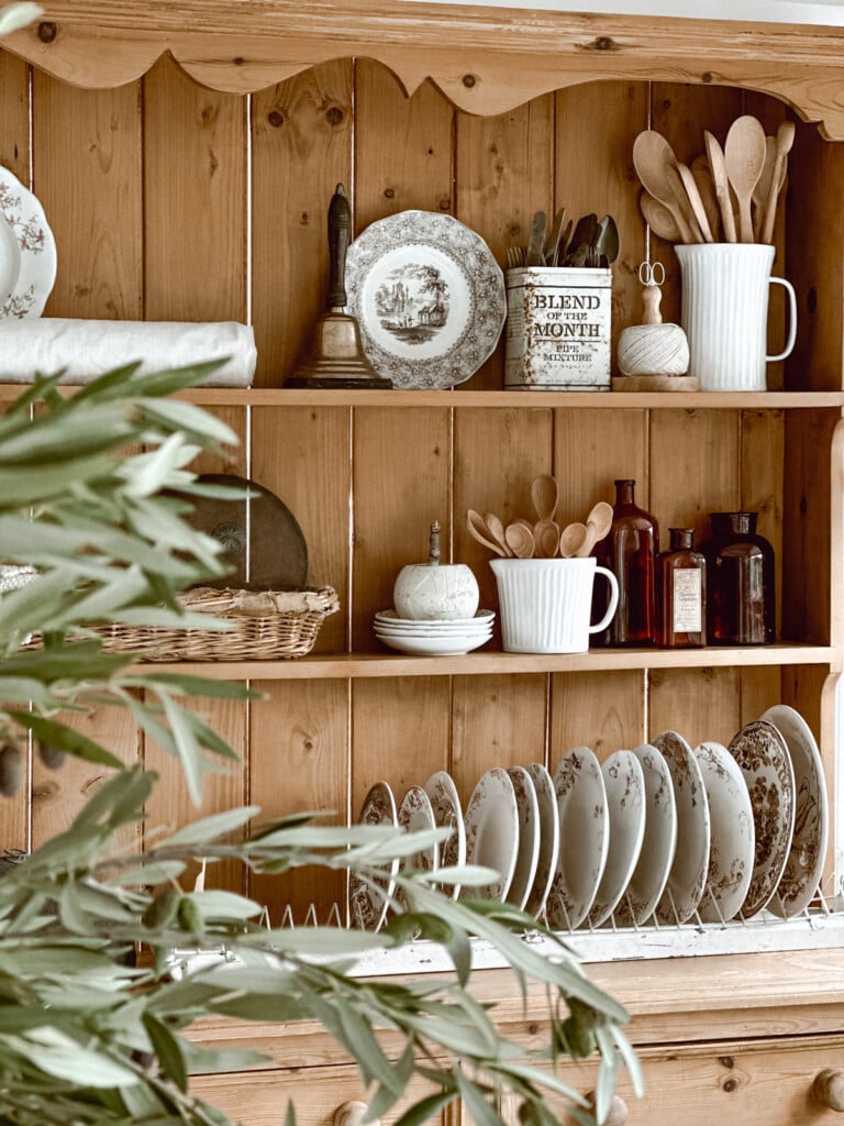 Pine hutch decorated for fall with brown and white Transferware