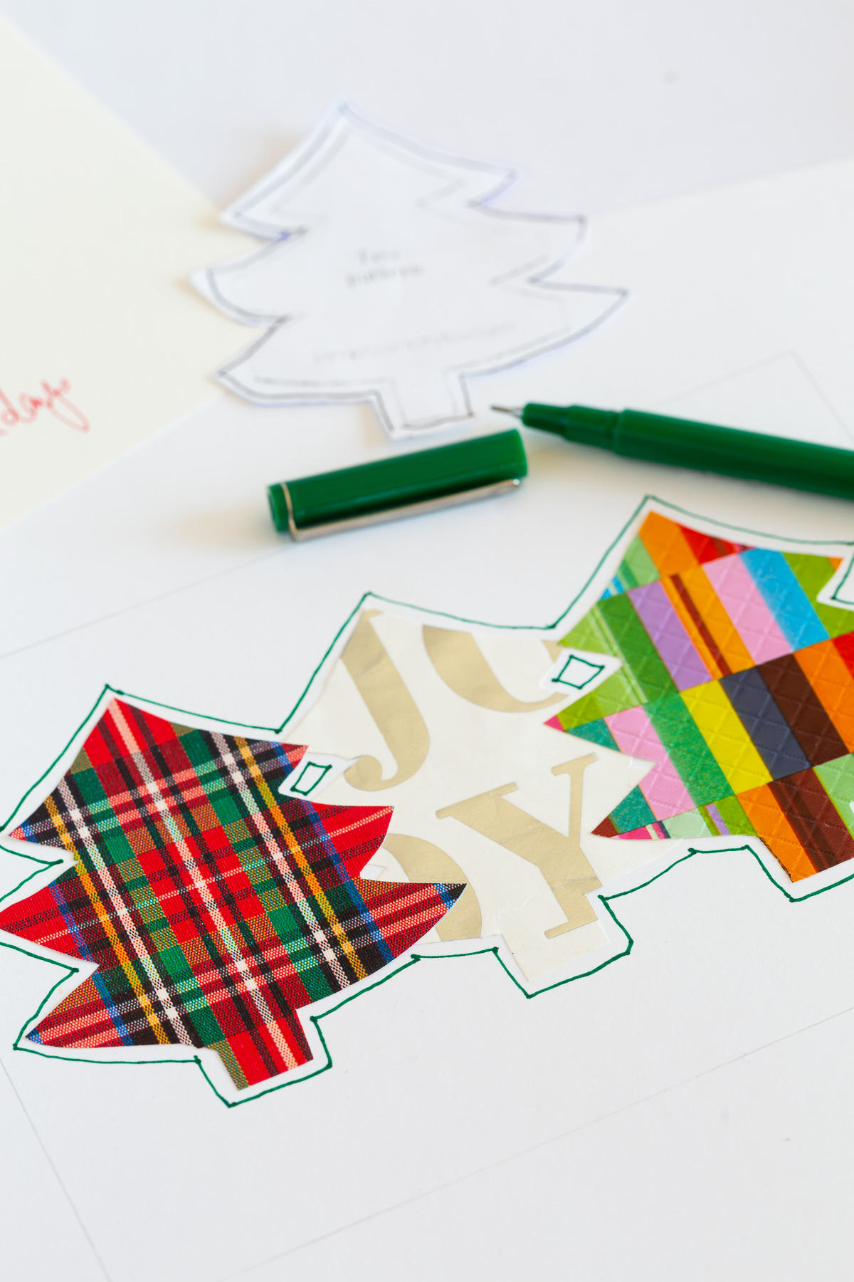 outline the cutout gift wrap trees on card.