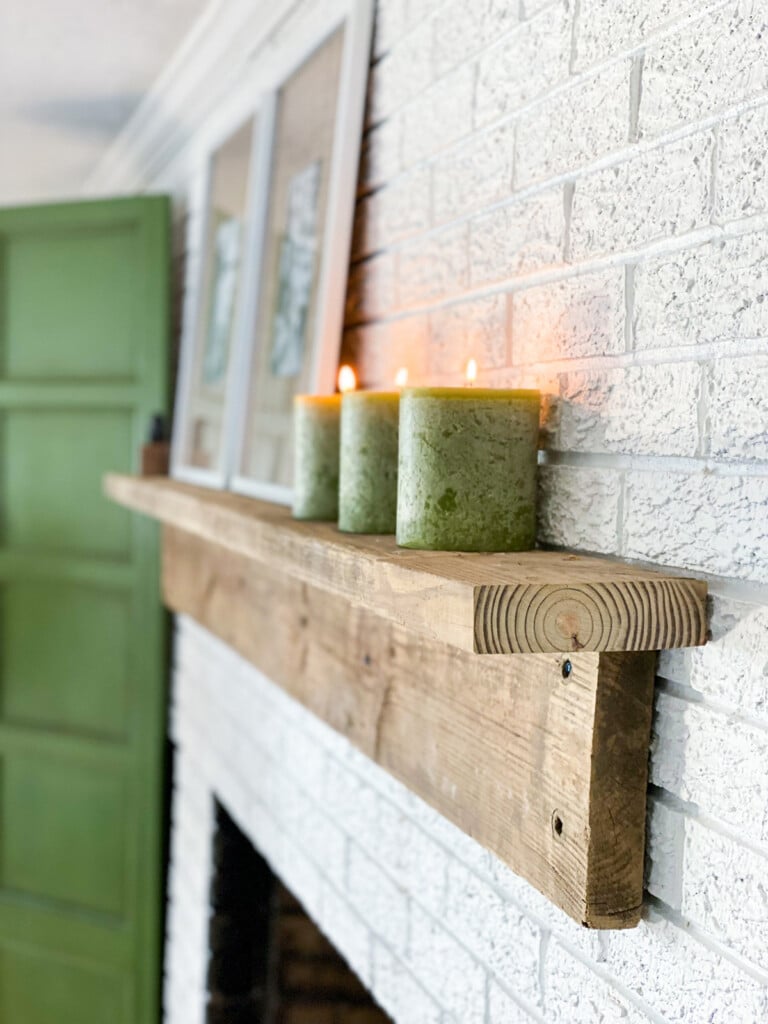 Easy to Build DIY Fireplace Mantel Shelf hung on brick wall.