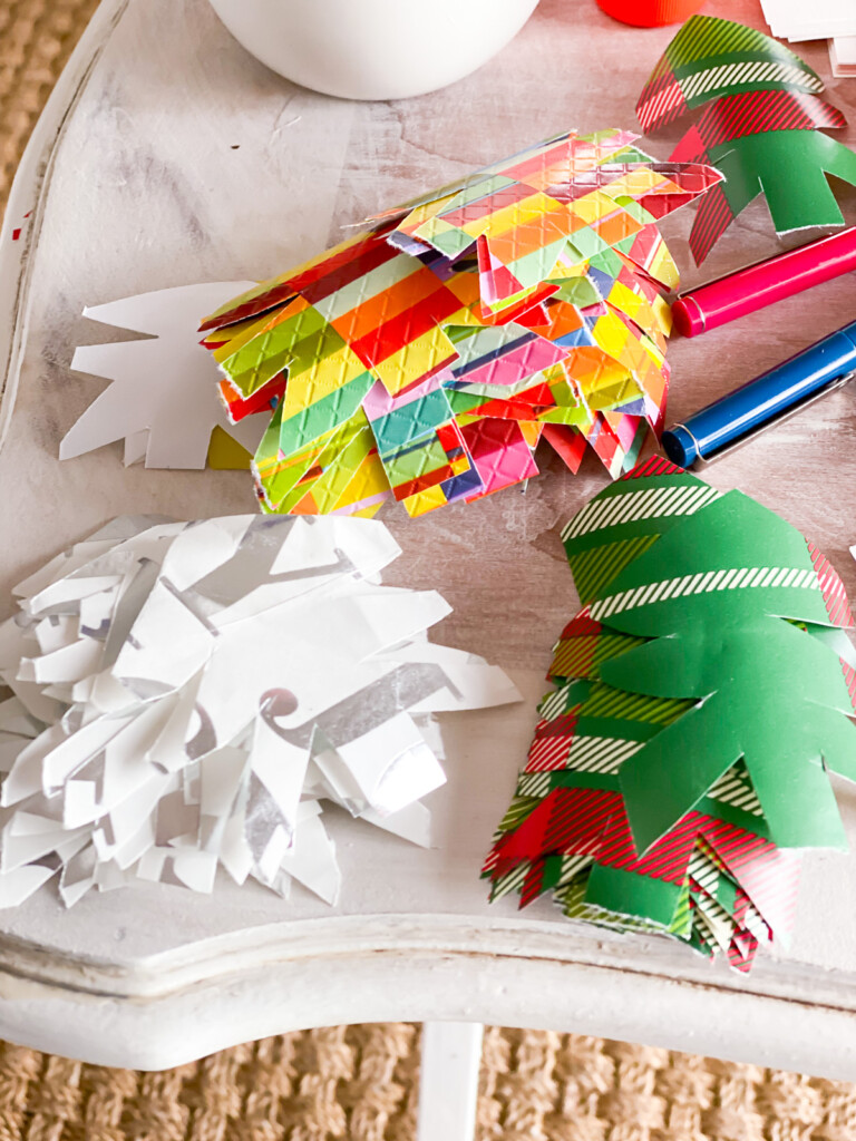Cut out Christmas tree shapes from holiday gift wrap