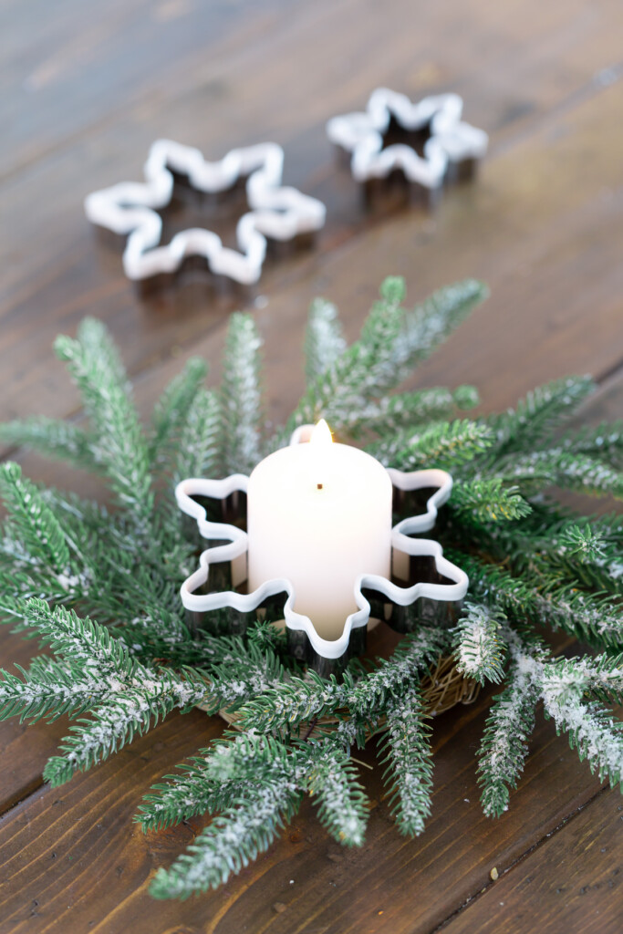 Snowflake cookie cutter used to hold a candle on a wreath as a Christmas decoration.