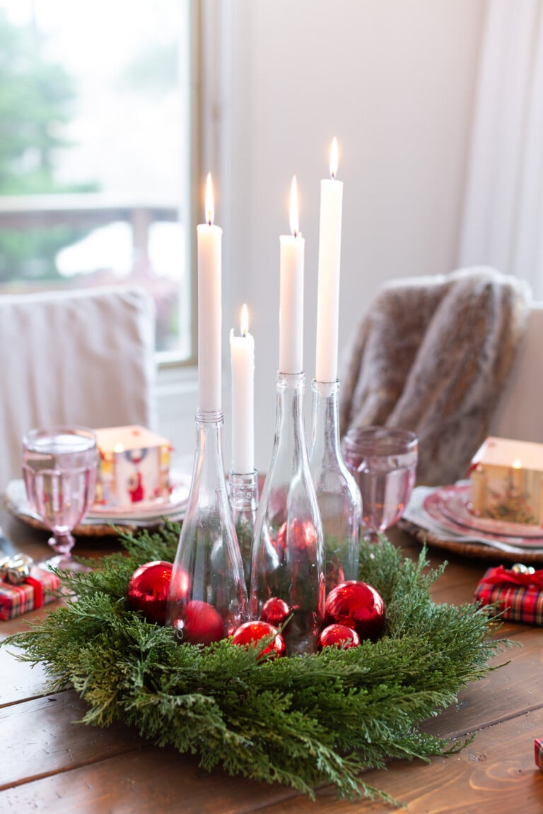 DIY clear bottle candle table centerpiece for Christmas dinner table setting.