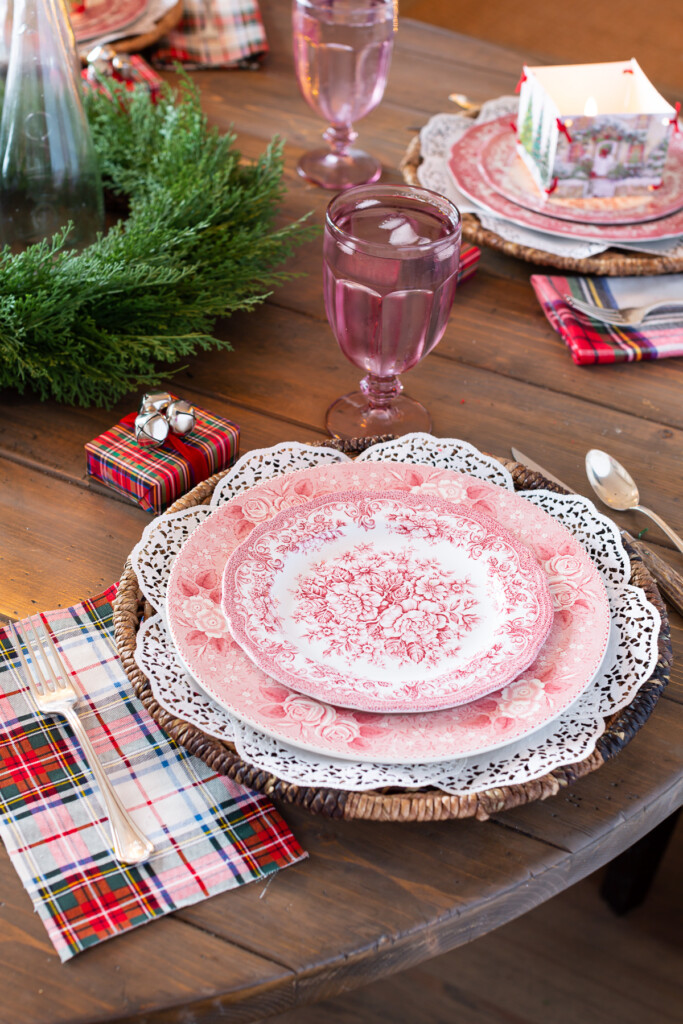red and white plates on white paper doily charger with red plaid accents.