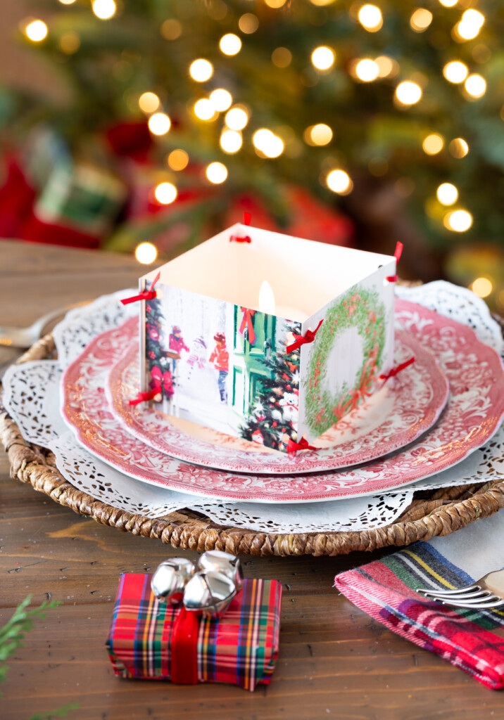 Christmas tablesetting idea using old Christmas cards to accent a small candle on a dinner plate.