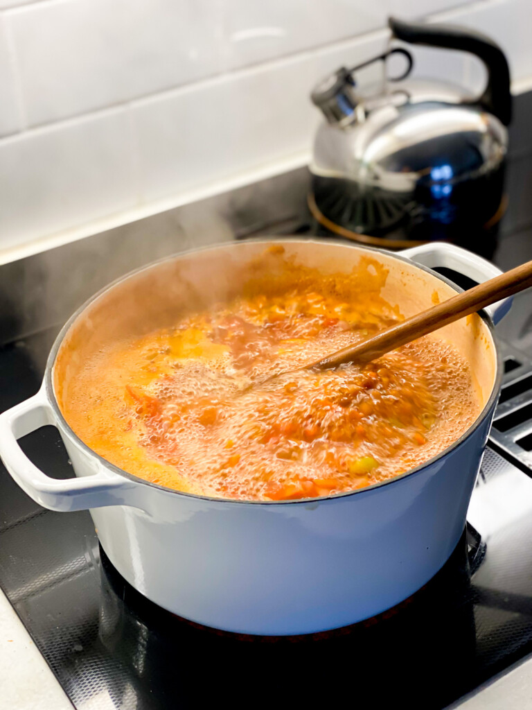 Rustic Tomato Soup cooking on a stove.