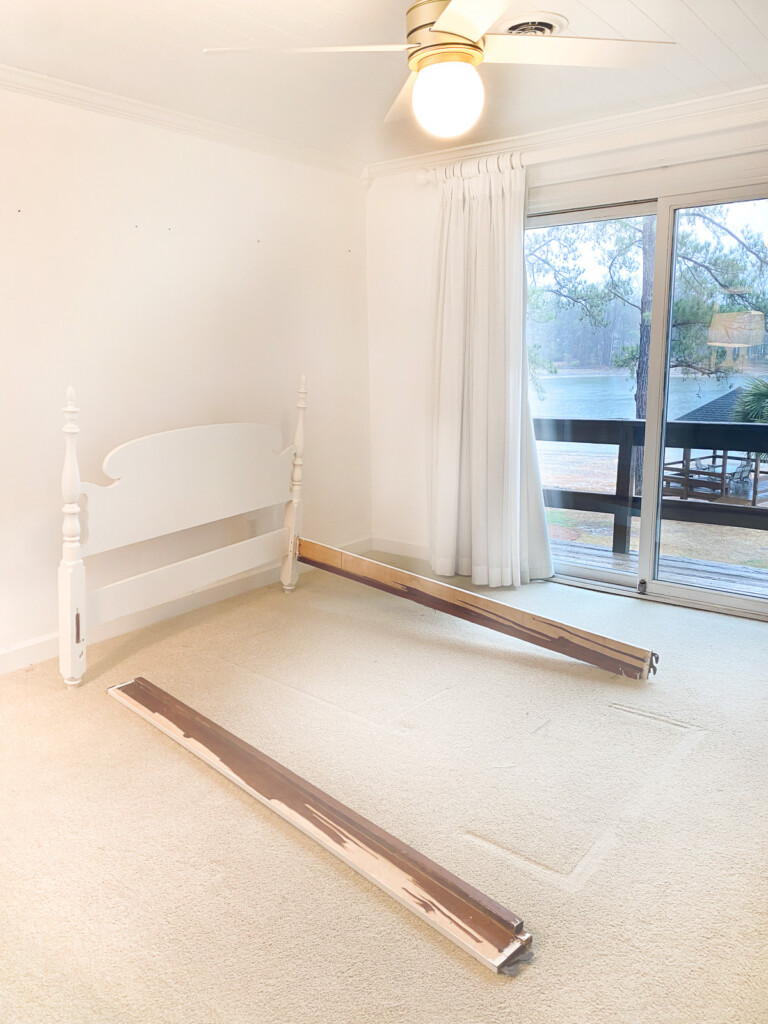 broken bed frame in empty bedroom