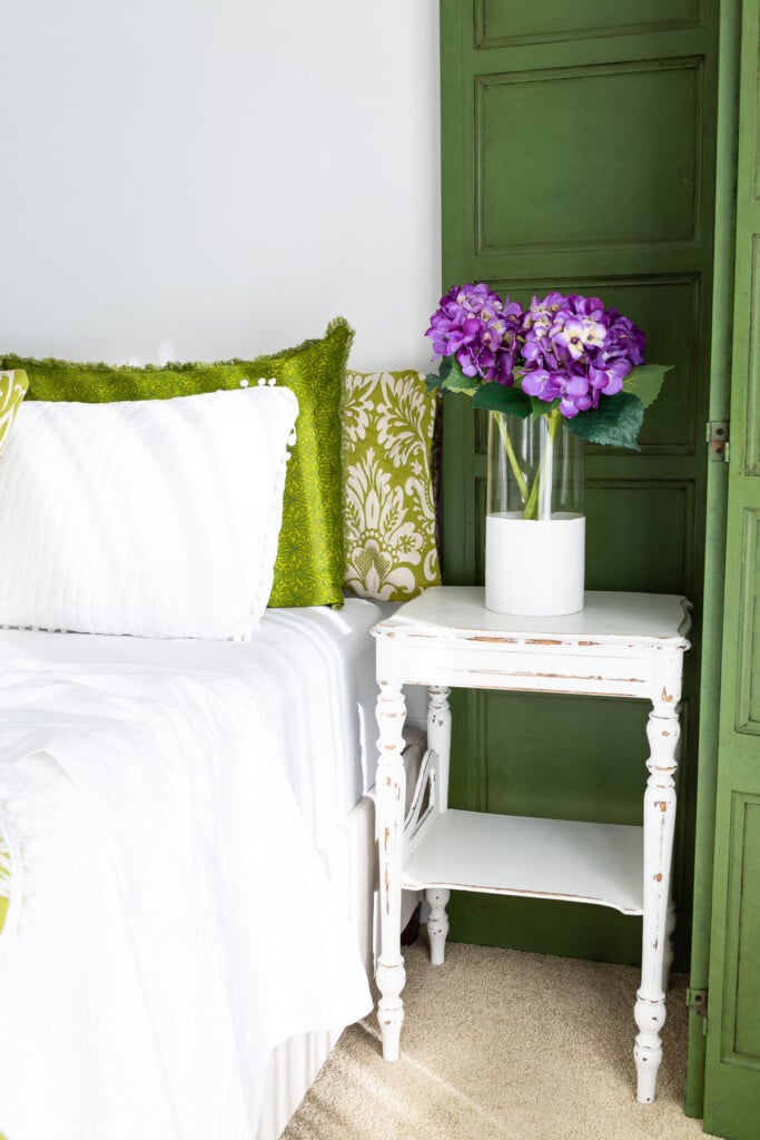 green and white guest room with purple accents
