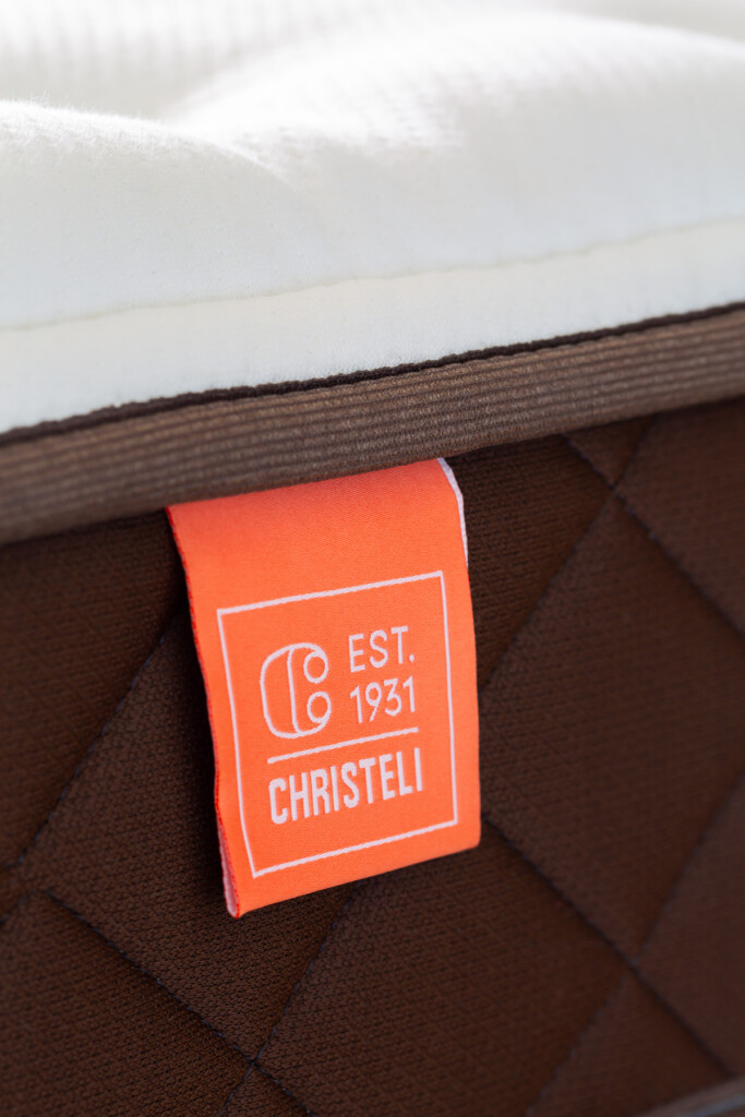 Orange Christeli mattress label that says Est. 1931