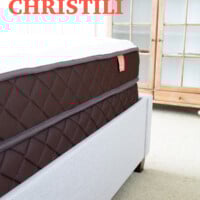 Christili mattress review - bed and upholstered frame side view.