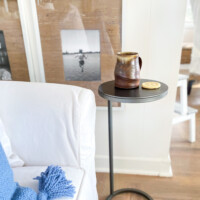 A Pottery Barn Duke Accent table by a white sofa.