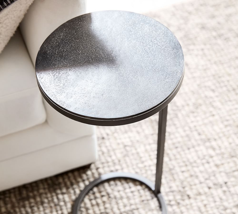 looking down on the top of a Duke round accent table from Pottery Barn in a living room.