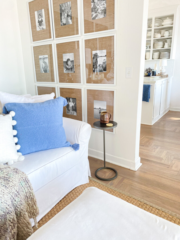 A corner in a living room with a sofa and small accent table to hold a drink.