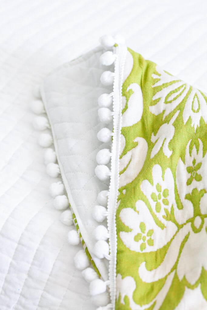close up of pom-pom trim detail on a DIY throw blanket.