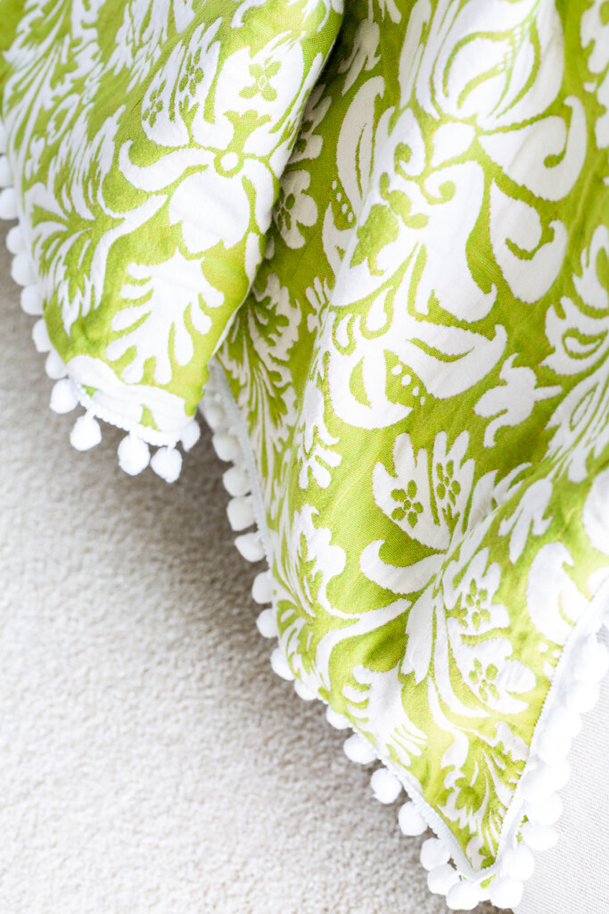 Close up of green and white large damask patterned DIY throw blanket.