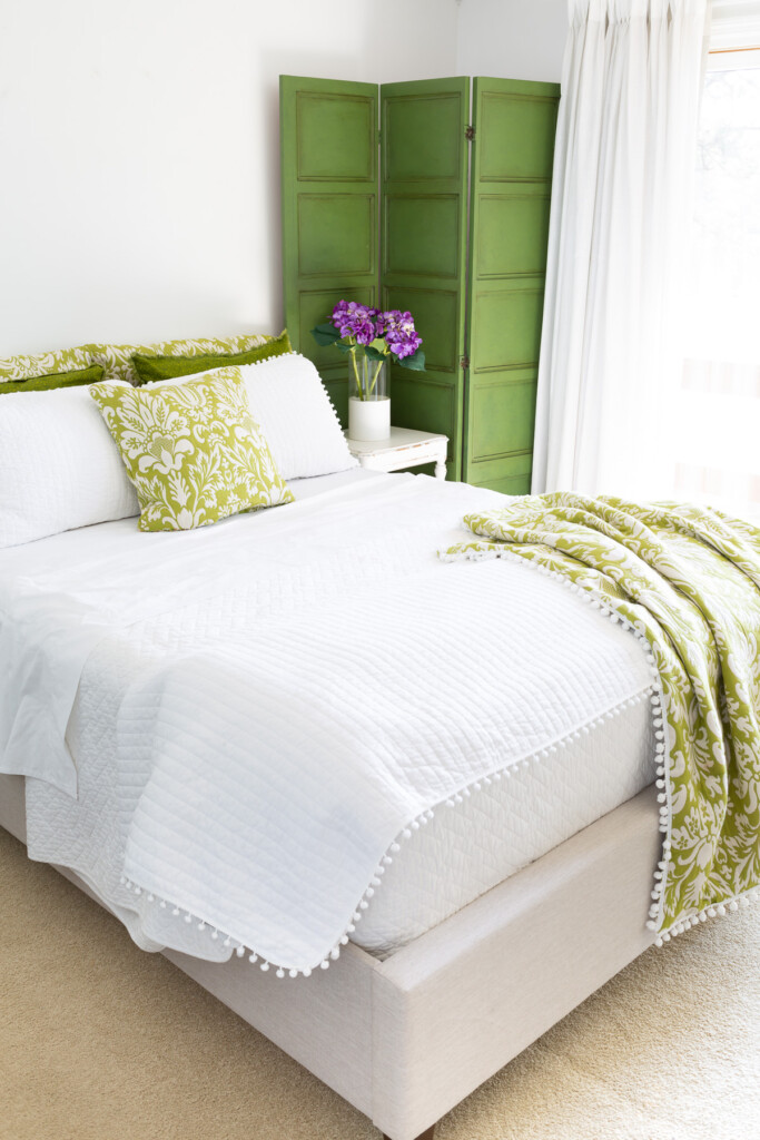 Looking into a green and white decorated guest room
