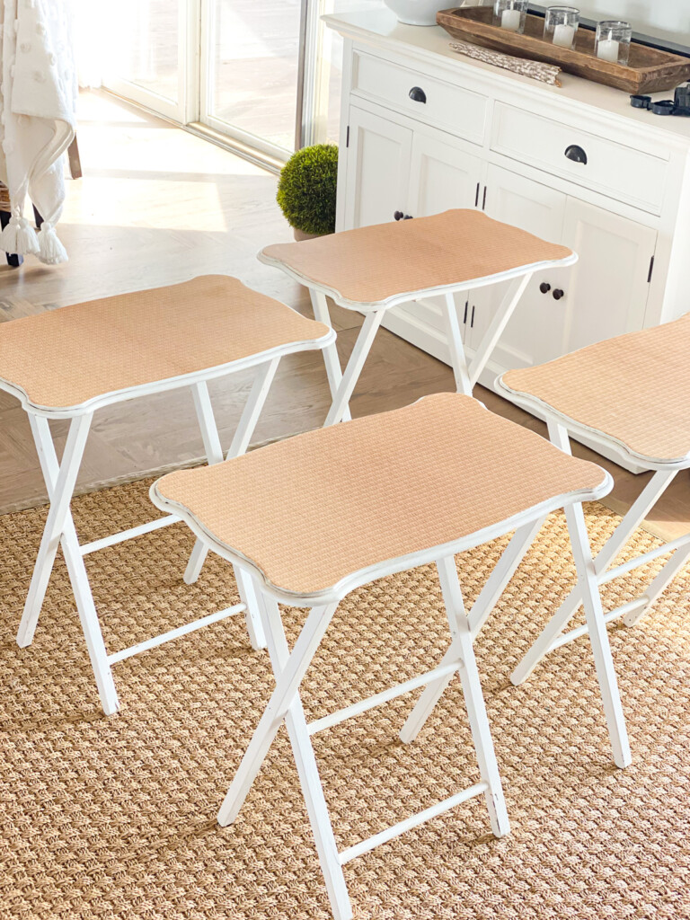 a set of 4 wood tray tables in a living room showing how nice they look after getting a makeover using wallpaper.