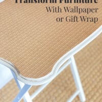 Wicker pattern gift wrap on top of a tray table. Text overlay says Transform Furniture With Wallpaper of Gift Wrap