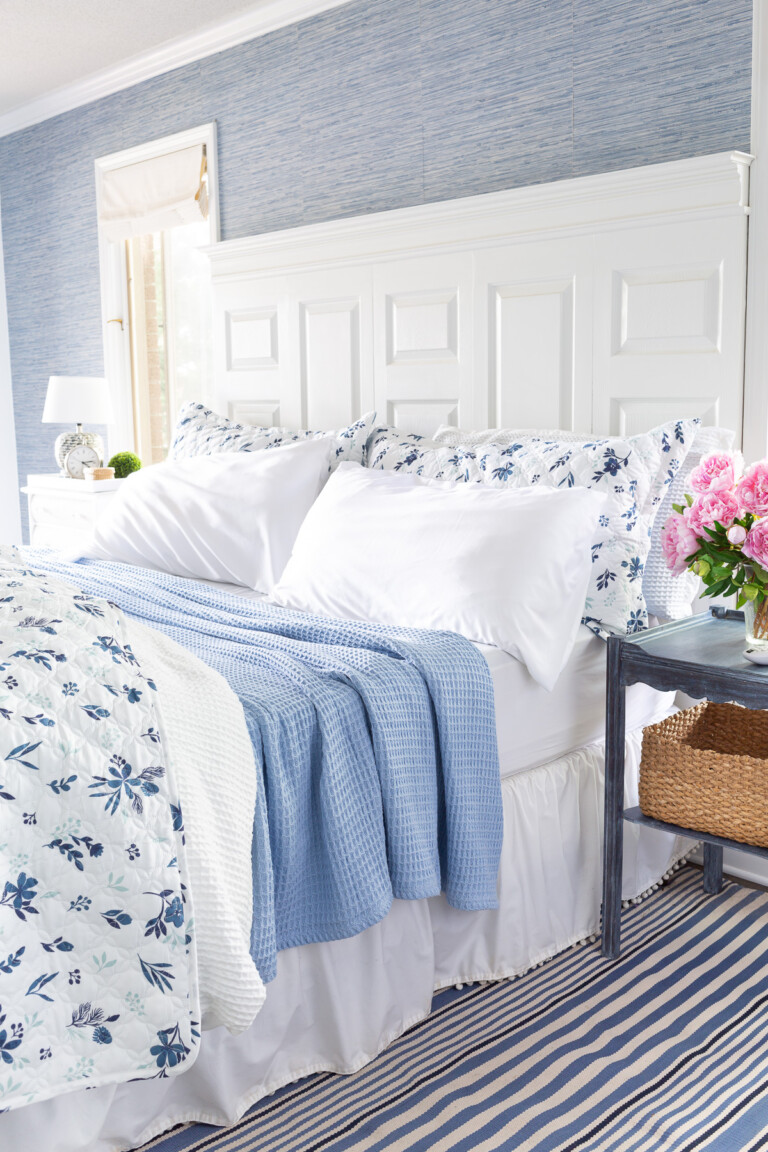 cozy lightweight summer floral bedding on a bed in a blue and white decorating color scheme.