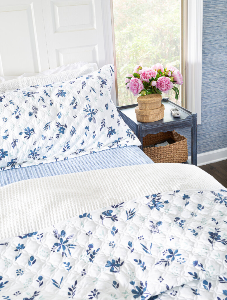 looking down on a bed made up using blues and white.