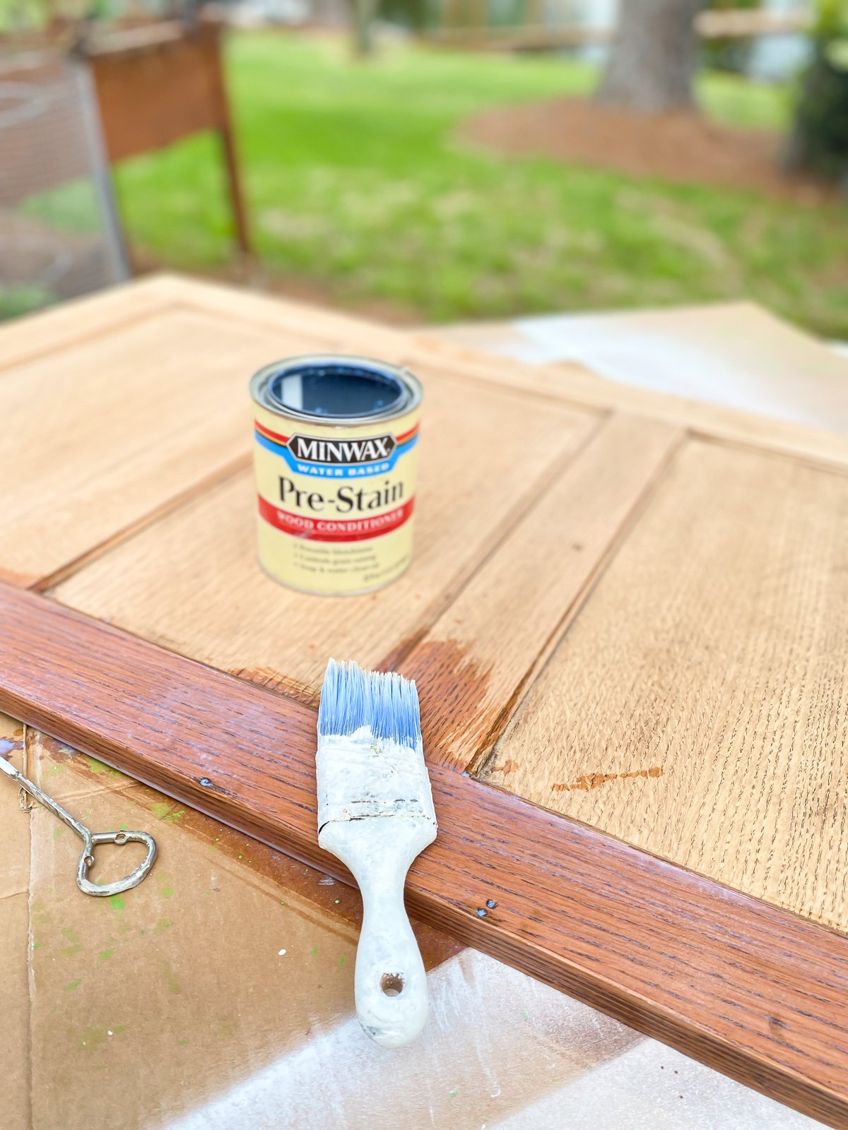 Brushing Minwax Water Based Pre-Stain on recessed panels from the sides of a old file cabinet.