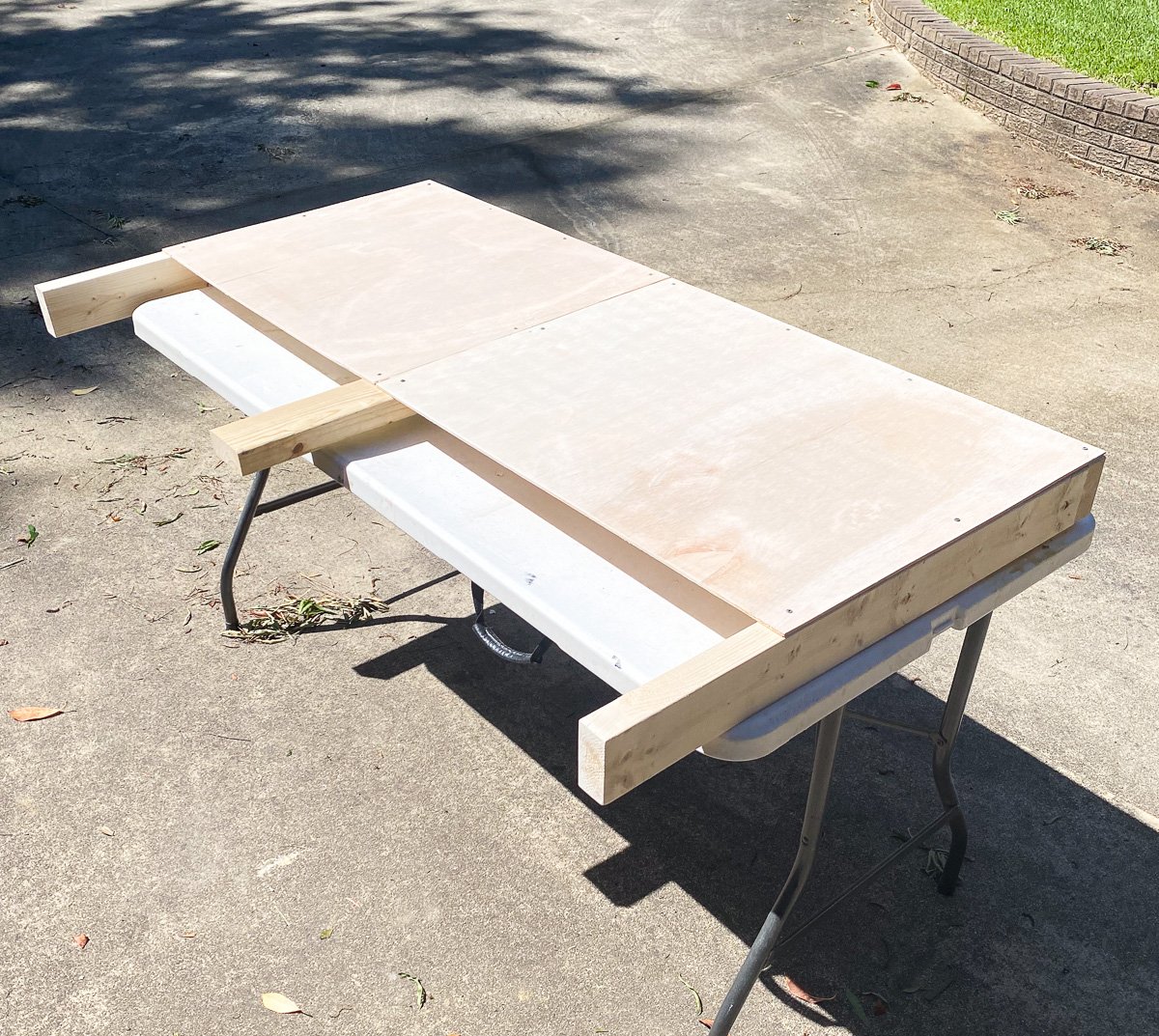 Finished wood frame to make a DIY upholstered headboard with legs.