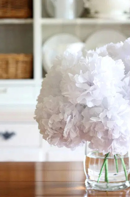 white flowers made with tissue paper in a glass vase