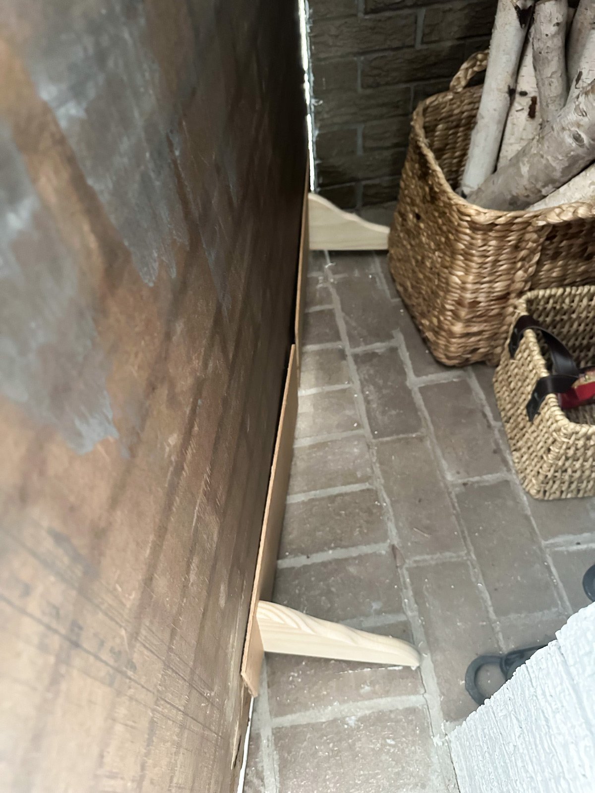 wood brackets behind the brick panel to help keep it in place.
