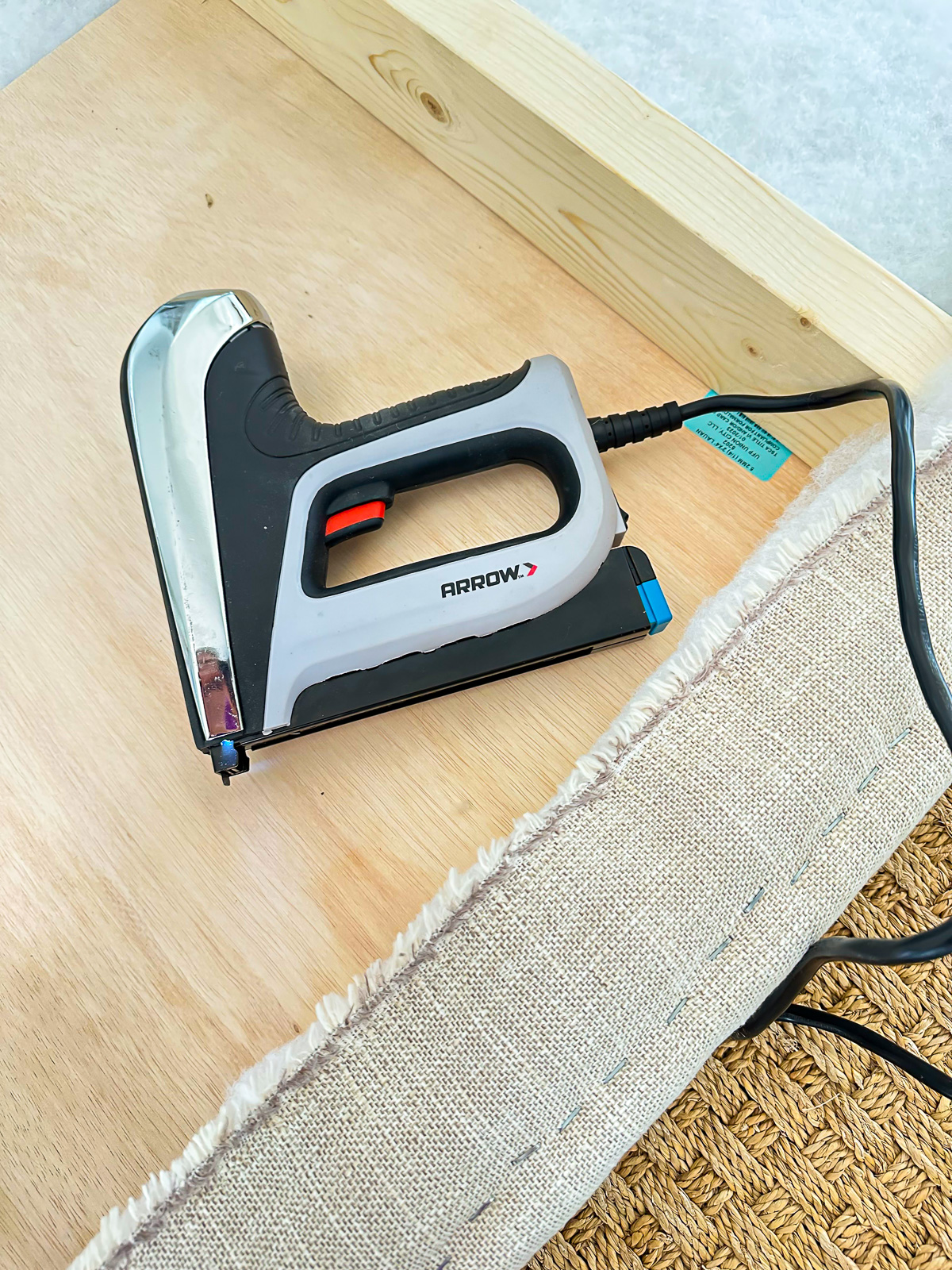 An electric staple gun makes it easy to attach fabric, batting and foam to make an upholstered bed headboard.