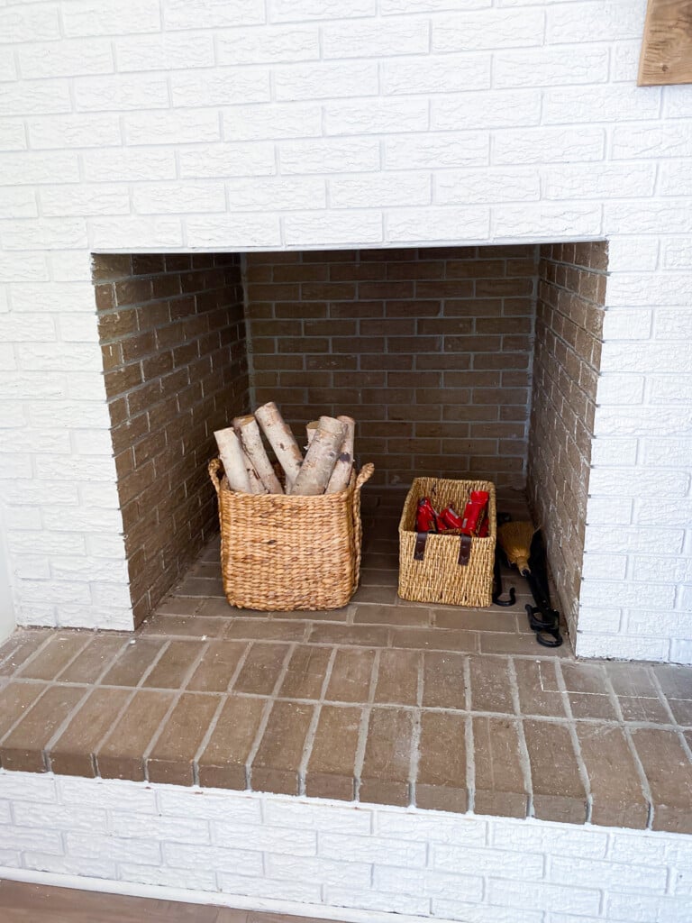 fireplace wood storage built into a brick wall in a living room