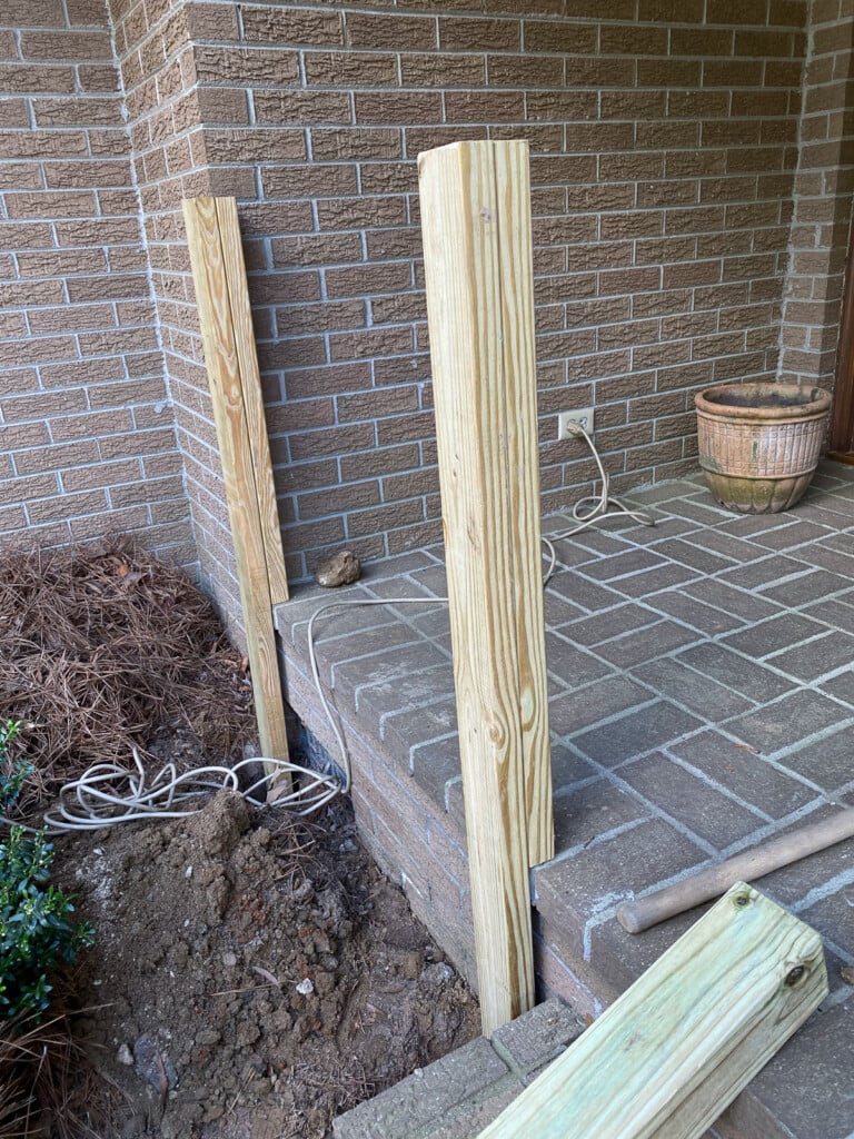 brick porch railing posts being installed