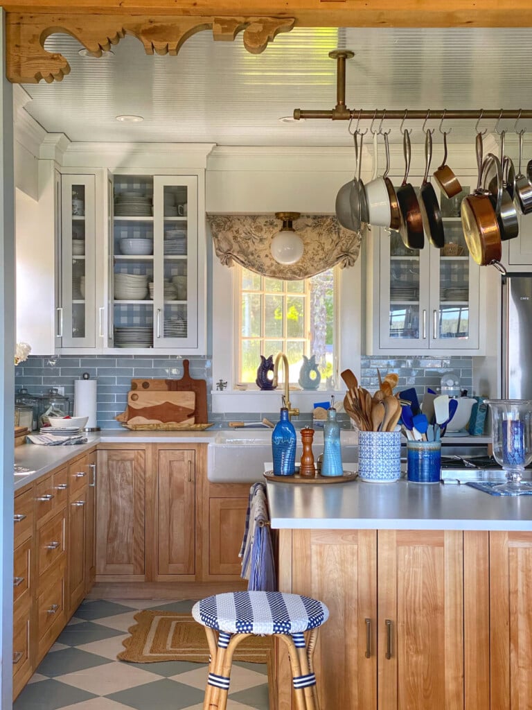 Molly in Maine kitchen with a painted checkerboard floor.