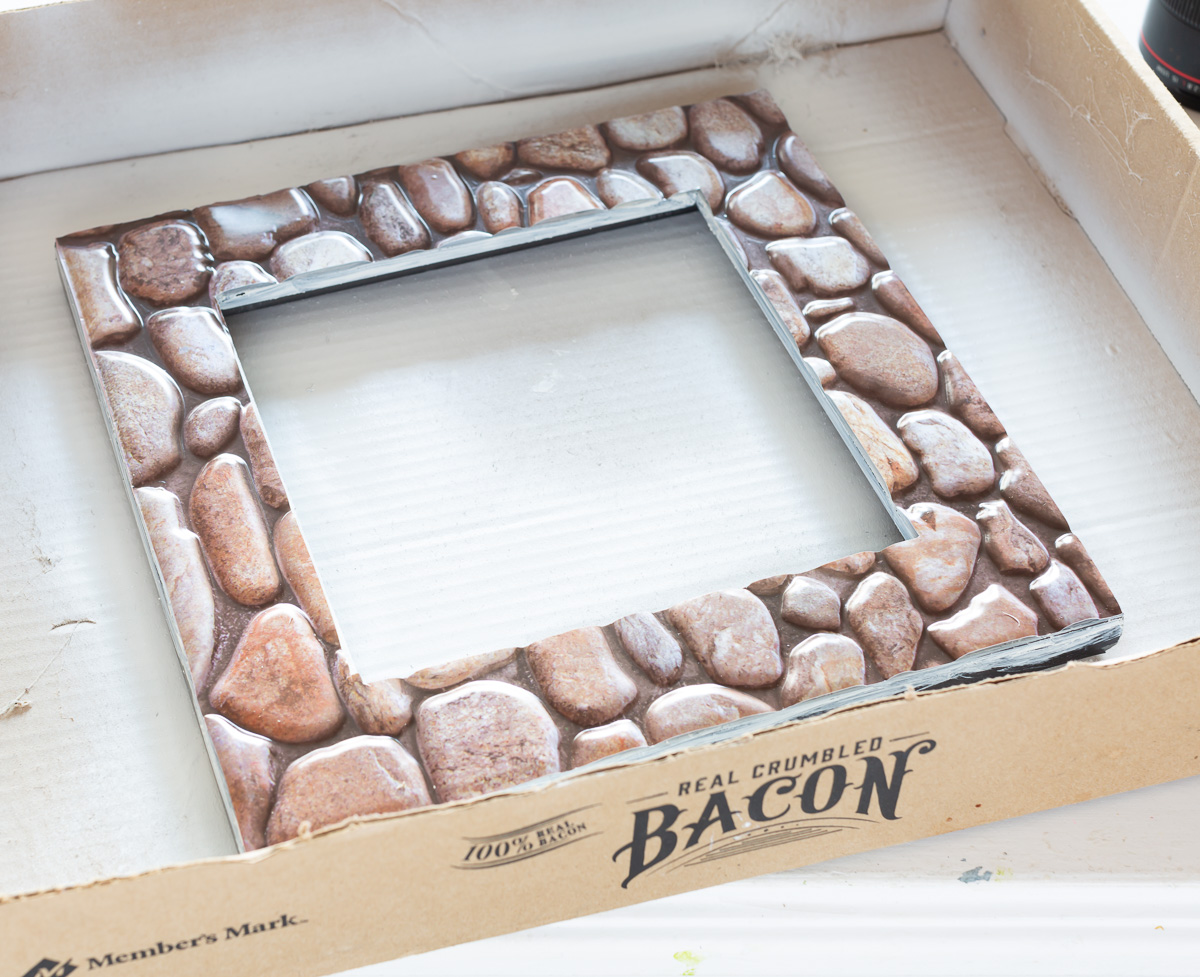 Adhesive faux stone tile from the Dollar Tree.