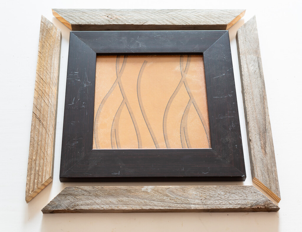 Cut scrap book to place around intact thrift store frame to make the frame larger.