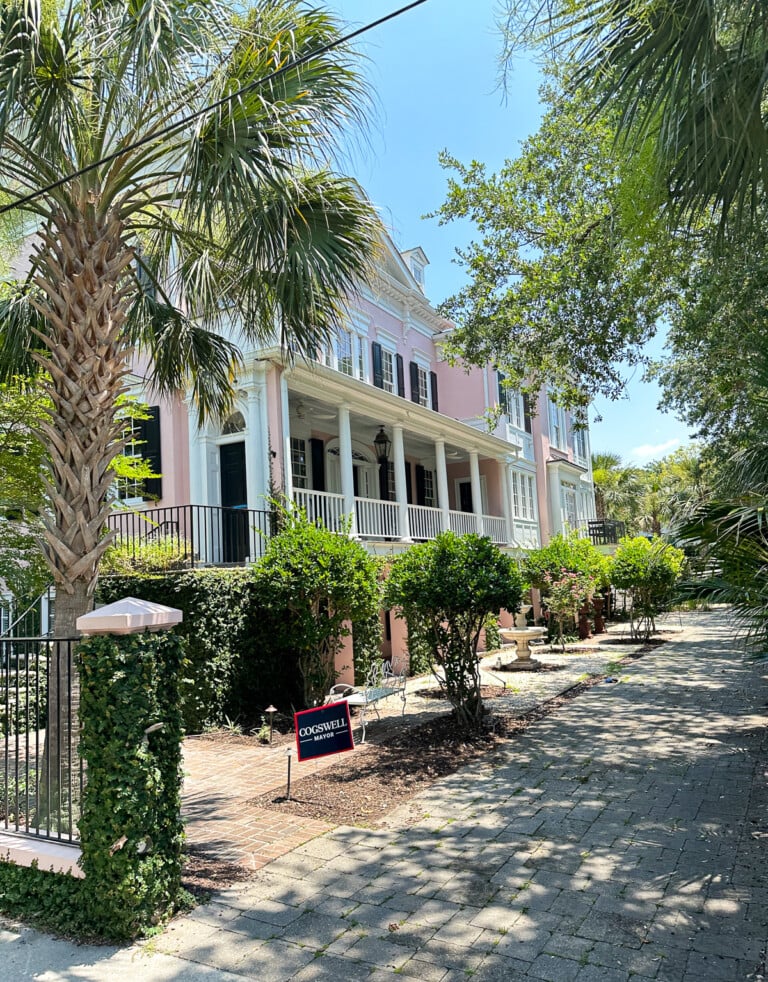 Pink Charleston home with a narrow lot where front of home is not facing the street.