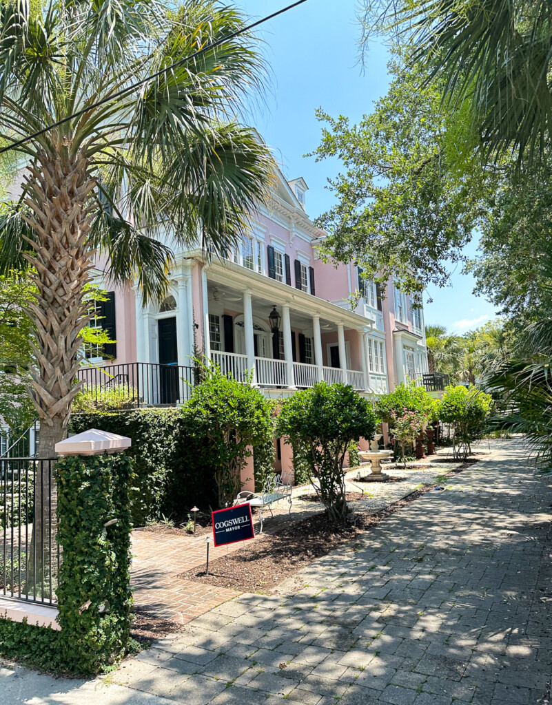 Pink Charleston home with a narrow lot where front of home is not facing the street.