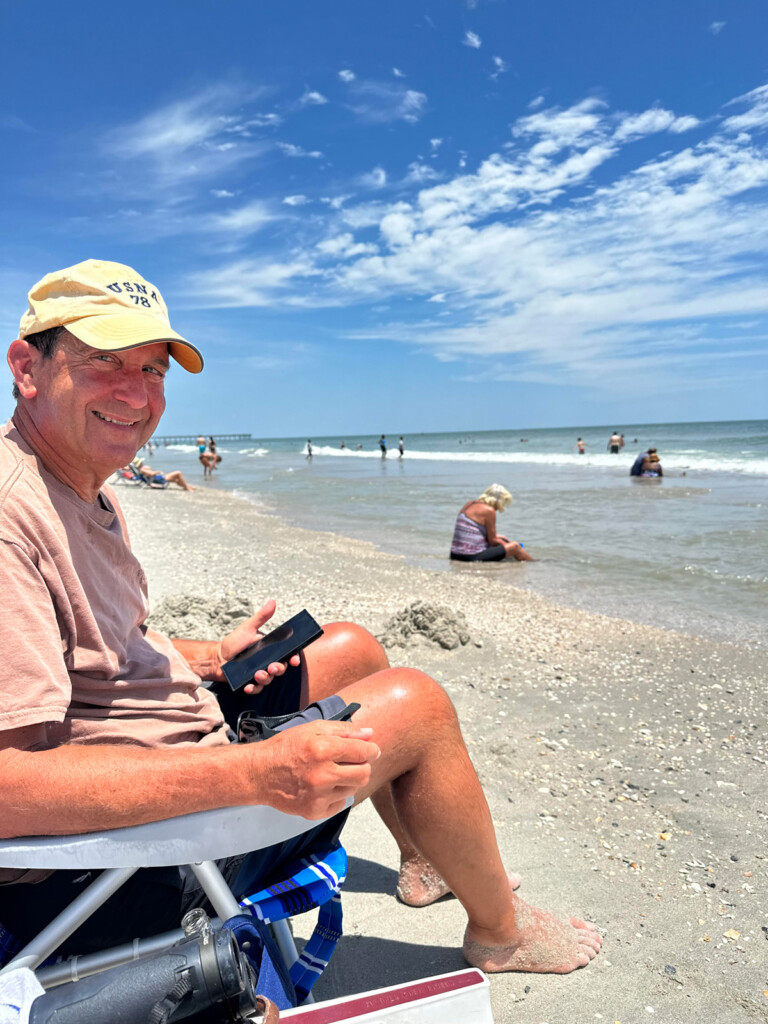 ed sitting on beach