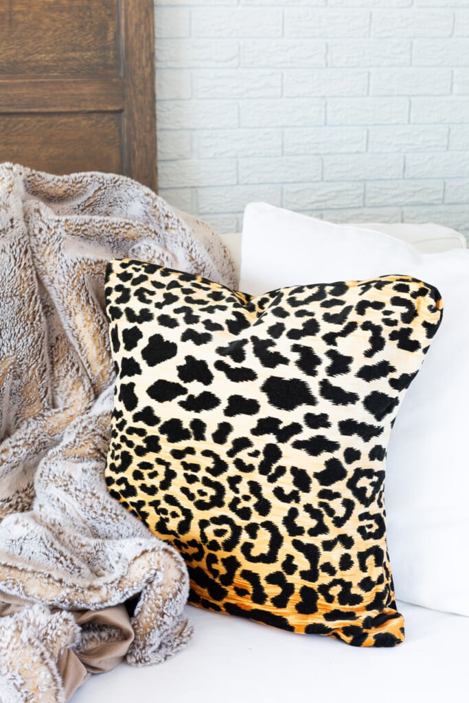 leopard print pillow on white sofa.