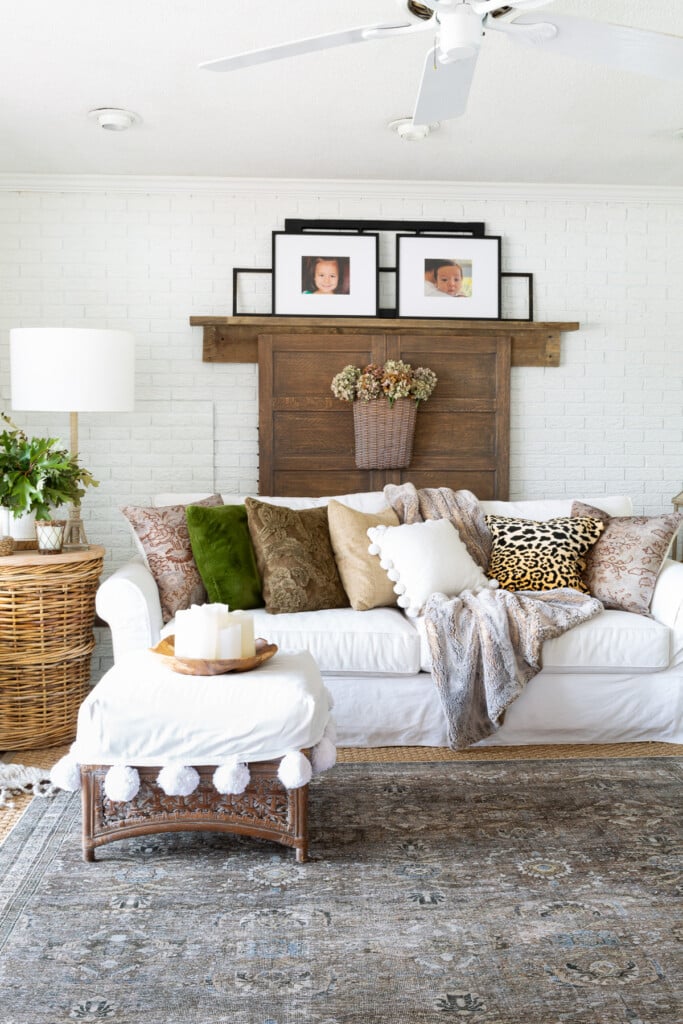 Decorated living room for fall using soft colors with an accent of green.