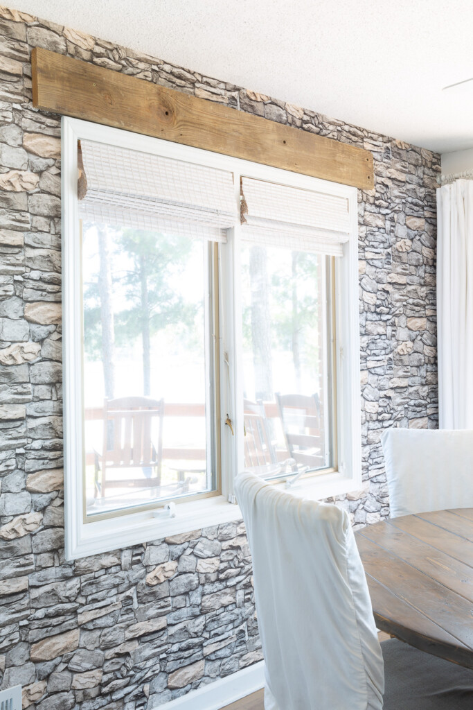 Accent wall in white kitchen covered with peel and stick wallpaper that resembles