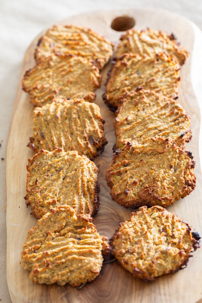 10 healthy cookies cooling on a wood board.