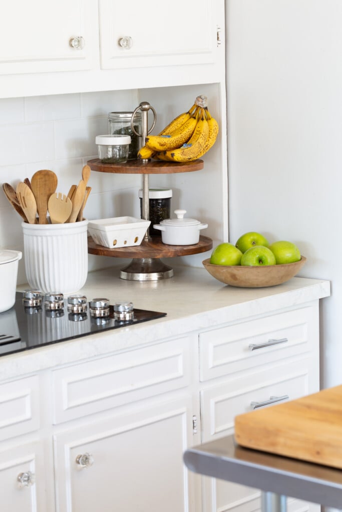 Kitchen counters in a small kitchen with painted countertops to resemble Carrara marble.